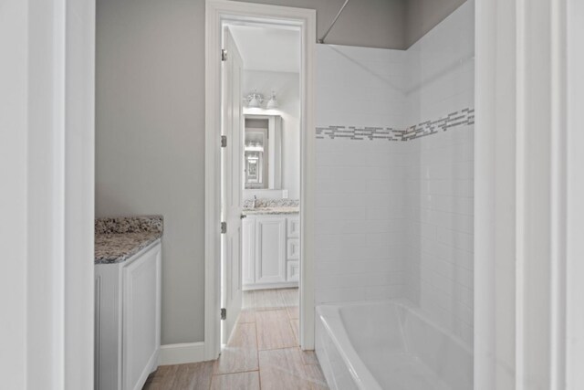 bathroom featuring vanity and tiled shower / bath