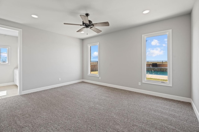 carpeted empty room featuring ceiling fan