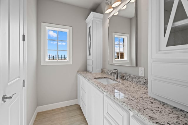 bathroom with vanity and hardwood / wood-style floors