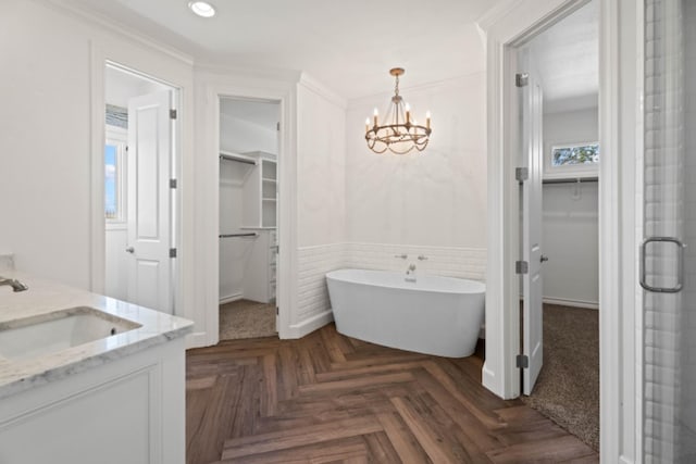 bathroom with separate shower and tub, vanity, ornamental molding, parquet floors, and a chandelier