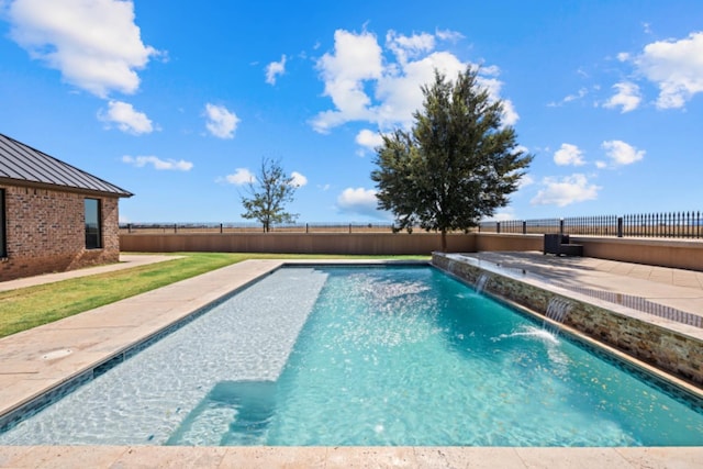 view of swimming pool featuring pool water feature and a patio