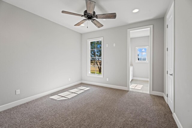 empty room featuring ceiling fan and carpet flooring