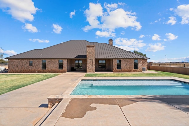 view of swimming pool featuring a yard and a patio