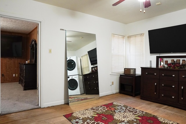 2007 25th St, Lubbock, TX 79411 - living room with stacked washer and clothes dryer, ceiling fan, light wood-type flooring, and baseboards
