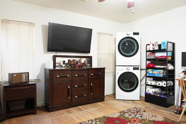 2007 25th St, Lubbock, TX 79411 - washroom with estacked washer and dryer, light wood-style floors, and a ceiling fan