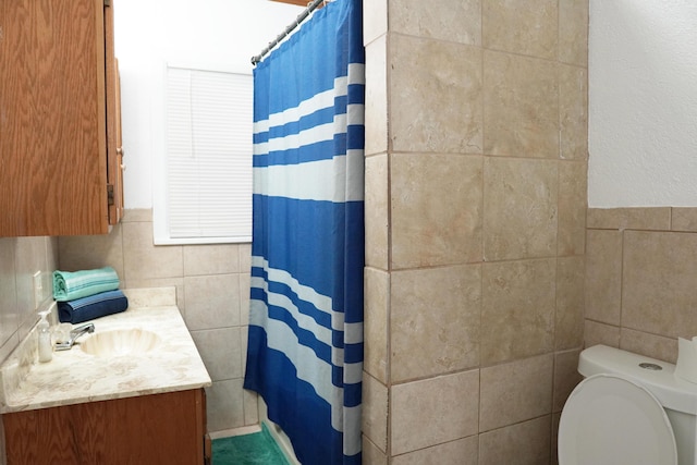 2007 25th St, Lubbock, TX 79411 - bathroom with tile walls, toilet, vanity, and curtained shower