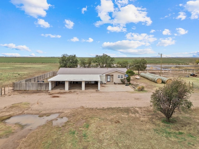 view of front of property with a rural view and an outbuilding