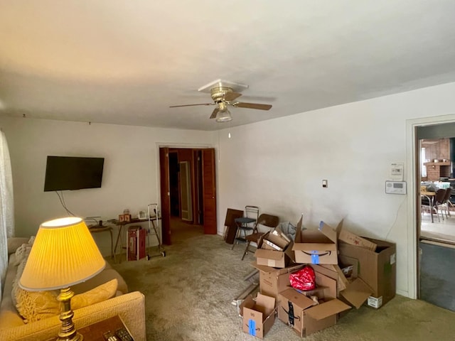 living room with ceiling fan and carpet flooring