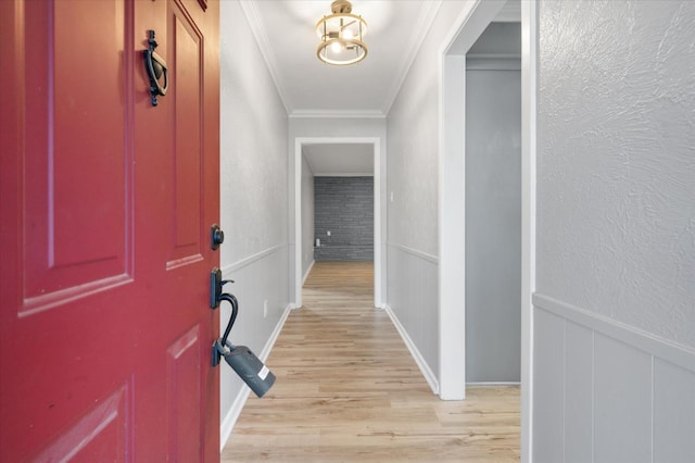 hall featuring ornamental molding and light wood-type flooring