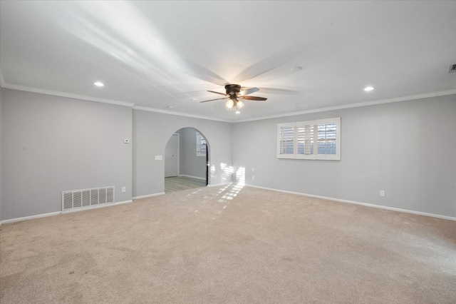 carpeted empty room featuring crown molding and ceiling fan