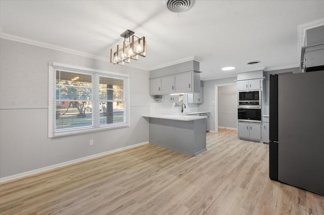 kitchen with sink, crown molding, appliances with stainless steel finishes, kitchen peninsula, and light wood-type flooring