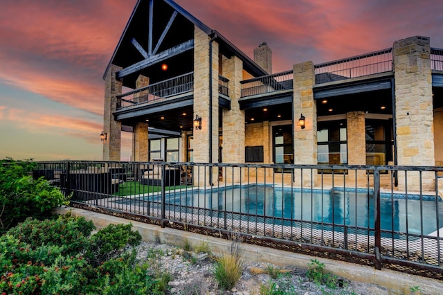 view of pool at dusk