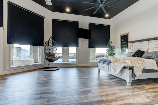 bedroom with light hardwood / wood-style flooring and a high ceiling