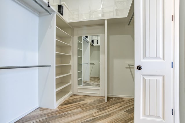 spacious closet featuring light hardwood / wood-style floors