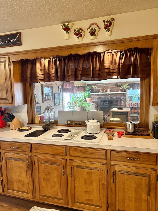 819 N Amherst Hwy, Earth, TX 79031 - kitchen featuring a textured ceiling and white electric stovetop
