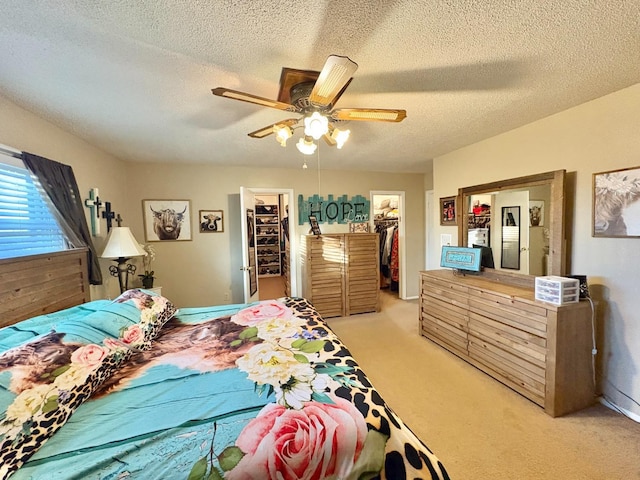 819 N Amherst Hwy, Earth, TX 79031 - carpeted bedroom featuring ceiling fan, a walk in closet, a closet, and a textured ceiling