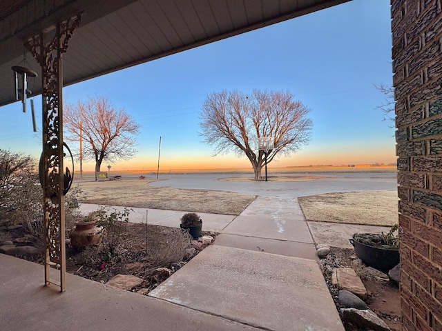 819 N Amherst Hwy, Earth, TX 79031 - yard at dusk with a water view