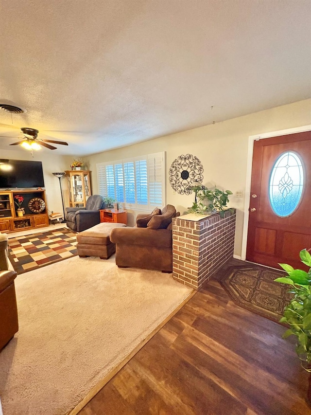 819 N Amherst Hwy, Earth, TX 79031 - living room with ceiling fan, dark hardwood / wood-style floors, and a textured ceiling