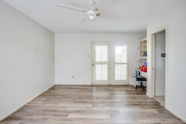 unfurnished room with a textured ceiling, ceiling fan, and light hardwood / wood-style flooring