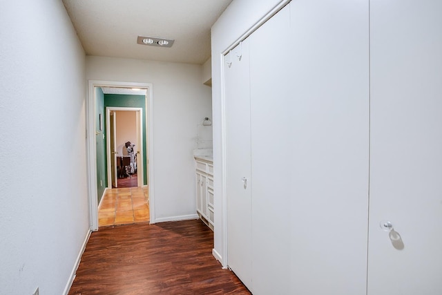 corridor featuring dark hardwood / wood-style flooring