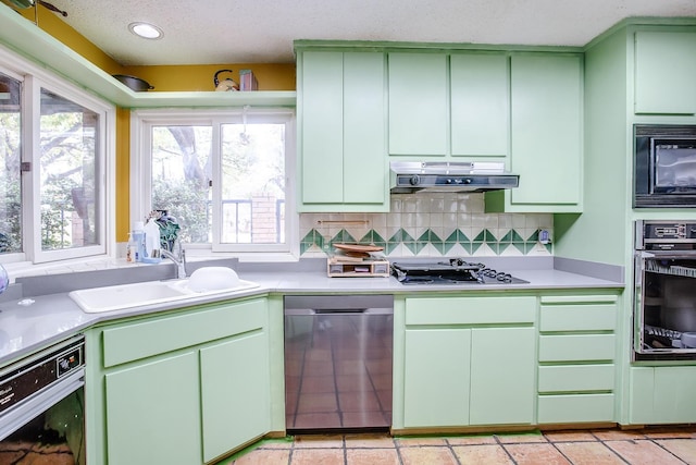 kitchen featuring green cabinetry, tasteful backsplash, sink, and black appliances