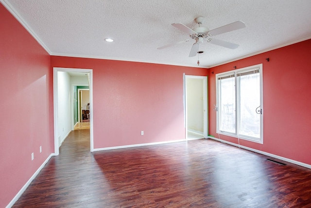 empty room with ornamental molding, dark hardwood / wood-style floors, a textured ceiling, and ceiling fan