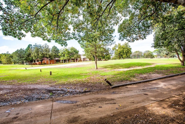 view of property's community with a lawn