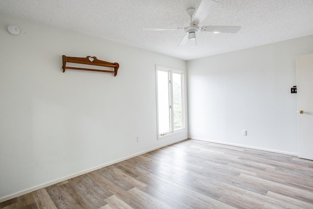 unfurnished room with ceiling fan, light hardwood / wood-style floors, and a textured ceiling