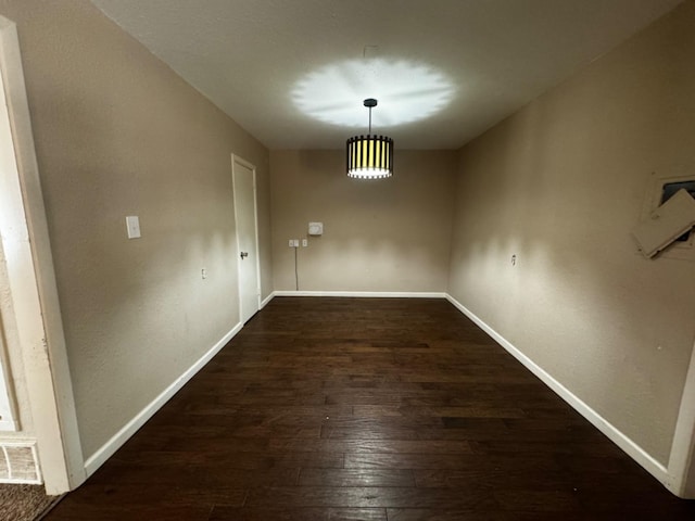 unfurnished dining area featuring dark wood-type flooring