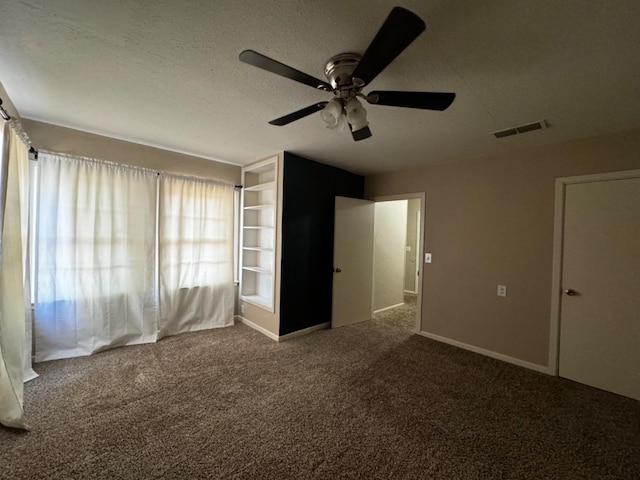 unfurnished bedroom with ceiling fan, carpet flooring, and a textured ceiling