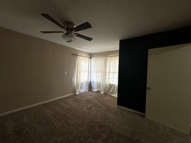 spare room featuring carpet floors and ceiling fan