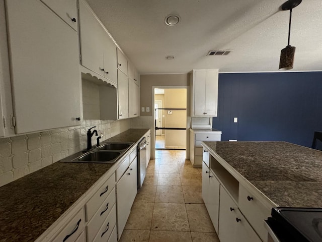 kitchen with pendant lighting, sink, dishwasher, white cabinets, and decorative backsplash