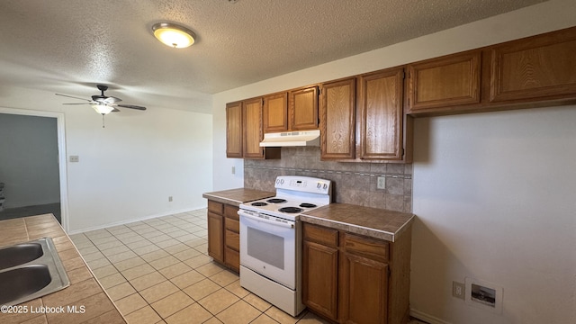 6210 22nd St, Lubbock, TX 79407 - kitchen with electric range, under cabinet range hood, brown cabinetry, ceiling fan, and backsplash