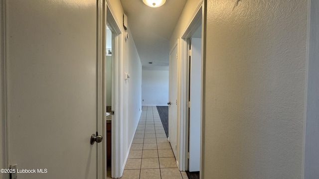 6210 22nd St, Lubbock, TX 79407 - corridor featuring light tile patterned flooring and a textured wall