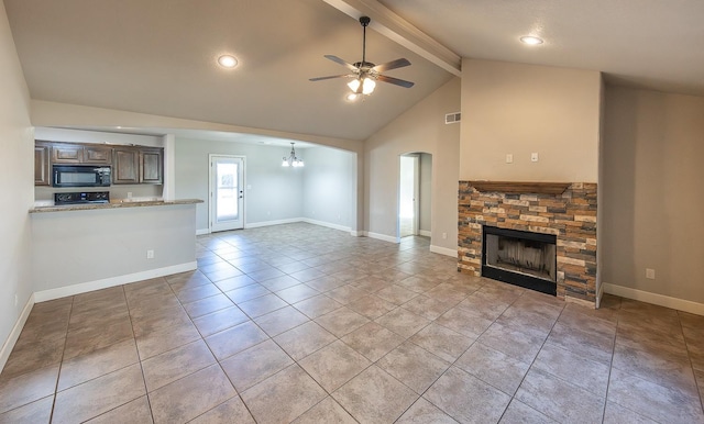 unfurnished living room featuring light tile patterned floors, ceiling fan with notable chandelier, high vaulted ceiling, a stone fireplace, and beamed ceiling