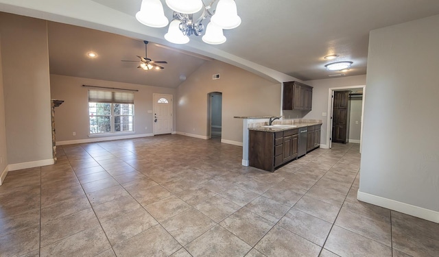 kitchen featuring light tile patterned floors, dishwasher, vaulted ceiling with beams, dark brown cabinets, and ceiling fan with notable chandelier