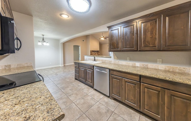 kitchen featuring dishwasher, sink, pendant lighting, and light stone counters