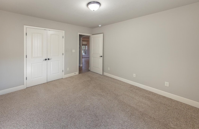 unfurnished bedroom with carpet flooring and a closet