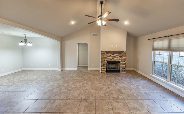 unfurnished living room featuring light tile patterned floors, ceiling fan with notable chandelier, a fireplace, and vaulted ceiling