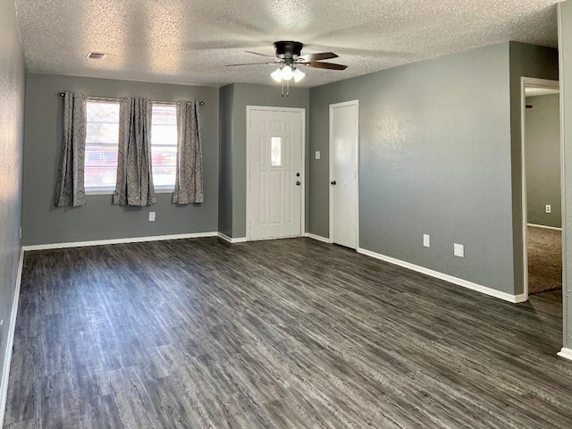 foyer with ceiling fan, dark hardwood / wood-style flooring, and a textured ceiling