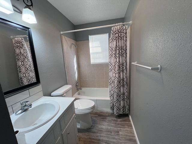 full bathroom featuring shower / tub combo, hardwood / wood-style floors, vanity, a textured ceiling, and toilet