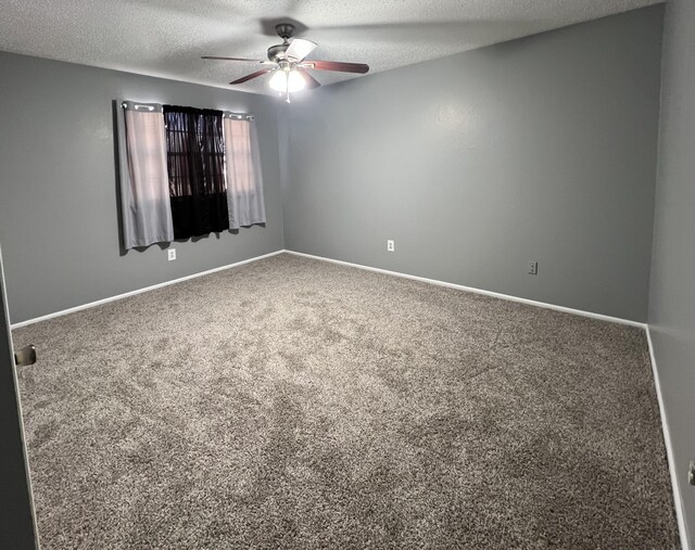 spare room with ceiling fan, carpet flooring, and a textured ceiling