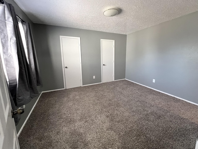 unfurnished bedroom with carpet and a textured ceiling