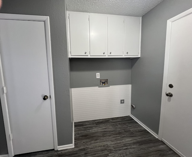 clothes washing area featuring cabinets, washer hookup, a textured ceiling, dark hardwood / wood-style flooring, and hookup for an electric dryer