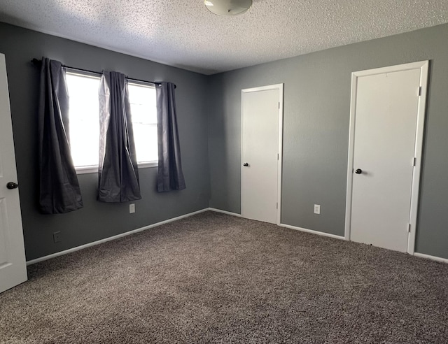 unfurnished bedroom with carpet floors and a textured ceiling