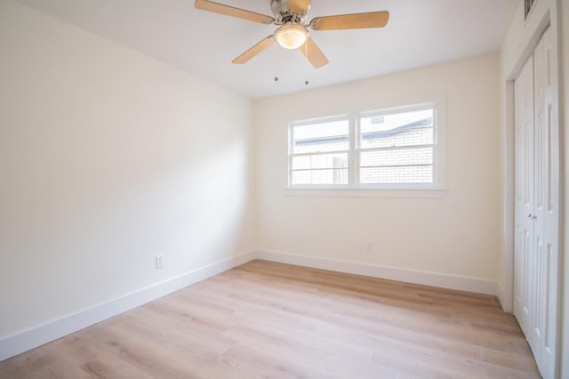 unfurnished bedroom with light hardwood / wood-style floors, a closet, and ceiling fan