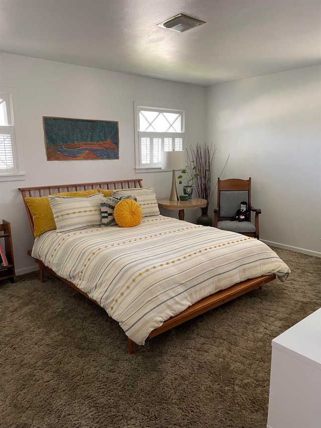 carpeted bedroom featuring multiple windows