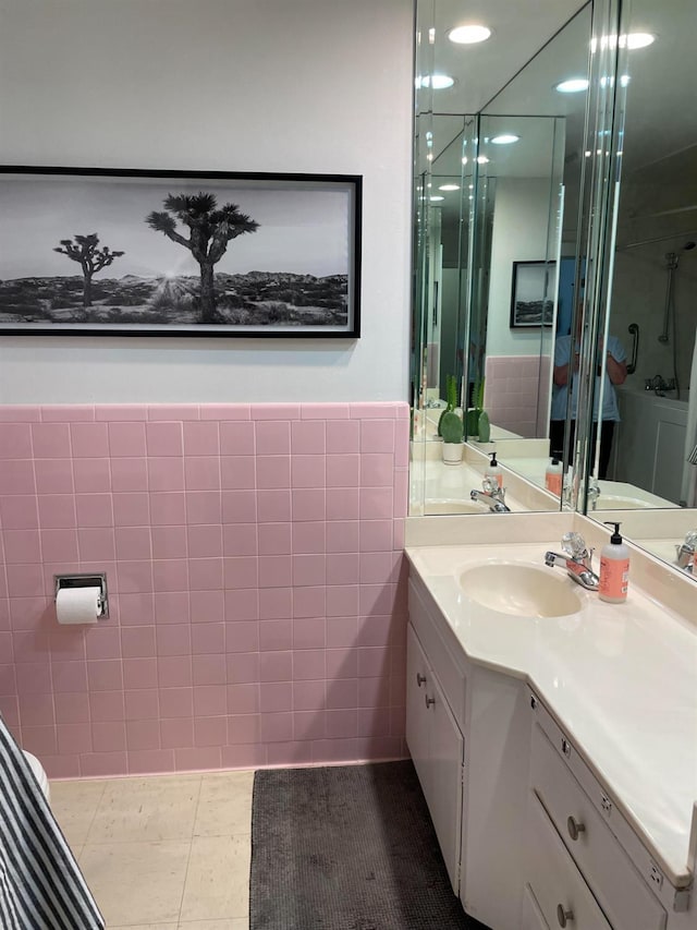 bathroom featuring tile patterned floors, vanity, and tile walls