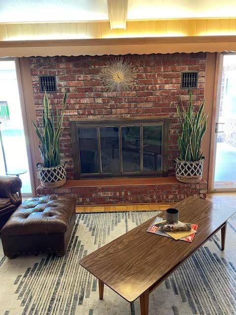 interior space featuring brick wall and a brick fireplace