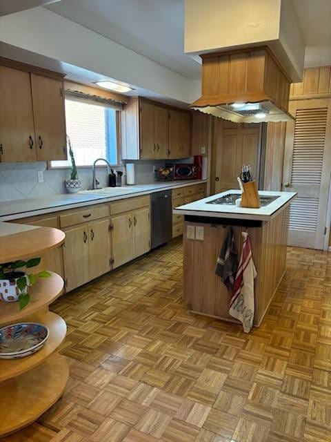 kitchen featuring sink, stainless steel dishwasher, a center island, and light parquet floors